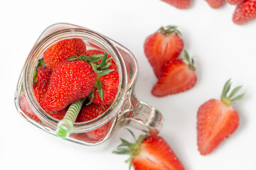 Fresh strawberry in ceramic jar on white
