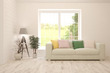 White living room with sofa and summer landscape in window. Scandinavian interior design. 3D illustration