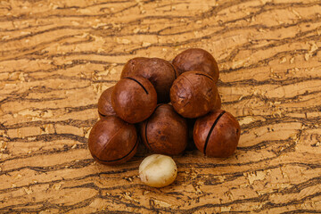 Brown macadamia nut heap over background