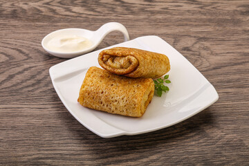 Staffed pancakes served sour cream