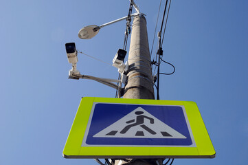 CCTV cameras mounted on a pole to monitor a pedestrian crossing