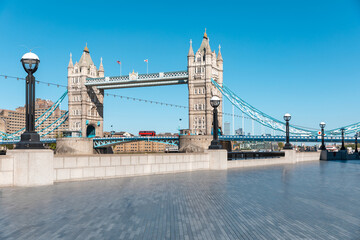 Tower Bridge in London with empty riverside walk due to coronavirus lockdown - London famous postcard view without people and tourists in the covid-19 era - architecture and travel