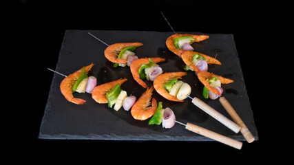 
Shrimp skewers arranged on a slate