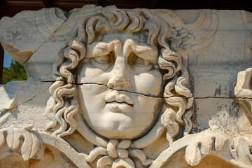 Head of man in the Temple of Apollo - Ancient Greek relief  - wall carving