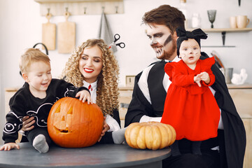 Fototapeta premium Mother father and children in costumes and makeup. Family prepare to celebration of Halloween.