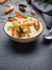 New England clam chowder, occasionally referred to as Boston or Boston-style Clam Chowder. Creamy soup with shrimp, corn, bacon and mussels