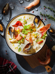 New England clam chowder, occasionally referred to as Boston or Boston-style Clam Chowder. Creamy soup with shrimp, corn, bacon and mussels