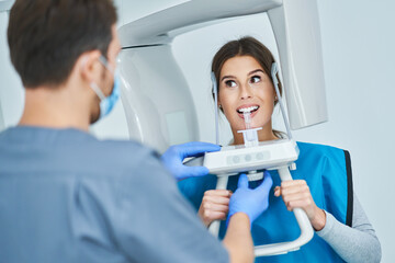 Dentist taking a panoramic digital xray of a patients teeth