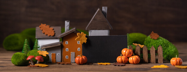 Miniature Thanksgiving little autumn cottages village in the forest, banner