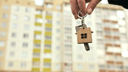 The concept of buying a new apartment. The girl holds the keys to a new apartment.