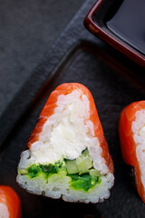 Seafood delicatessen salmon sushi rolls on plate