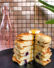 Pouring Syrup Over Fresh Pancakes