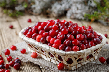 Basket with cranberries on a wooden table