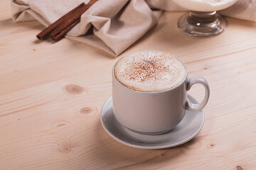 a white ceramic cup of cappucino as a coffee break concept