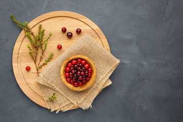 Northern forest berry cranberries on a round wooden cutting board. Menu concept