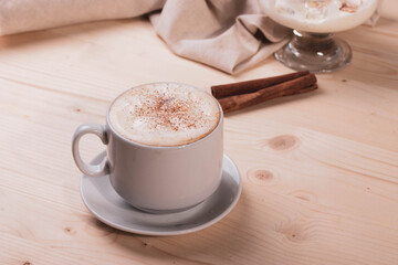 a white ceramic cup of cappucino as a coffee break concept