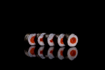 Fresh delicious beautiful sushi rolls on a dark background