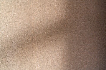 The brown wall shaded with sunlight.