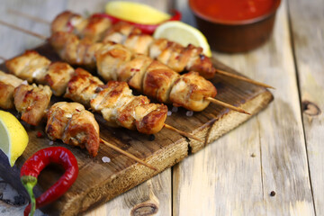 Chicken skewers on wooden sticks. Appetizing homemade mini barbecue. Selective focus. Macro.