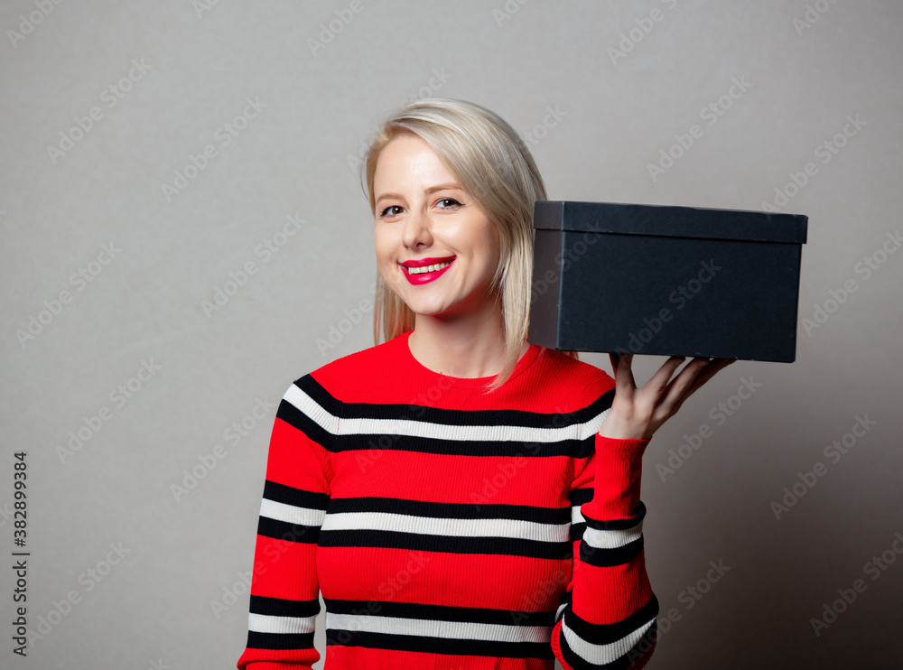 Wall mural style blonde girl with black gift box