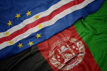 waving colorful flag of afghanistan and national flag of cape verde. macro