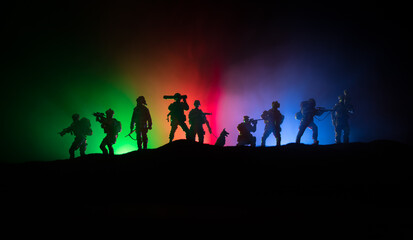 Fototapeta na wymiar Azeri army concept. Silhouette of armed soldiers against Azerbaijani flag. Creative artwork decoration. Military silhouettes fighting scene dark toned foggy background.