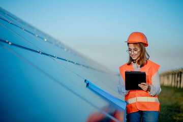 Inspector Engineer Woman Holding Digital Tablet Working in Solar Panels Power Farm, Photovoltaic...