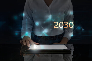 Business woman works on digital screen about 2030