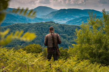 Hunter checking for prey high up in the mountains