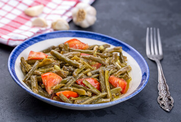 Fresh green cowpea salad with tomato and garlic.