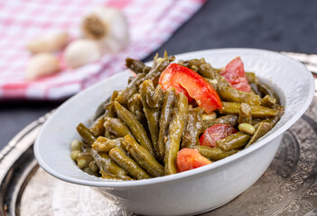 Fresh green cowpea salad with tomato and garlic.