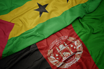 waving colorful flag of afghanistan and national flag of sao tome and principe . macro