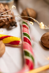 The atmosphere of Christmas and New Year. Colored lollipops and garland on white background