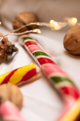 The atmosphere of Christmas and New Year. Colored lollipops and garland on white background