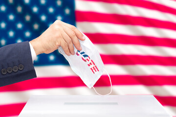 A man's hand voting in the US presidential election with the US
