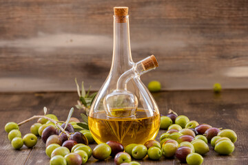 Natural olive oil and olives in glass bottles