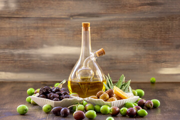 Natural olive oil and olives in glass bottles