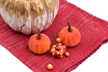 fall halloween pumpkin decoration still life isolated with berries on red mat