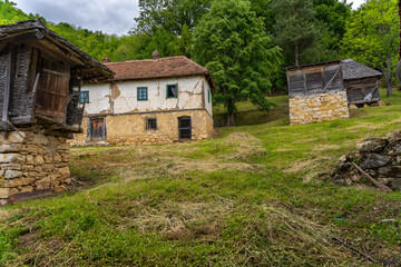 Fototapeta na wymiar Old rundown houses and surrounding objects in the countryside