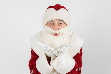Santa Claus blows off the palm. Isolated background.