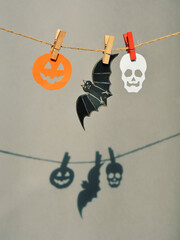 happy halloween card garland of pumpkin and skull. hard light and shadow on the background