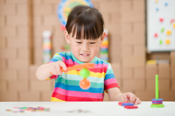 young  girl  play magical magnet experiments at home for homeschooling