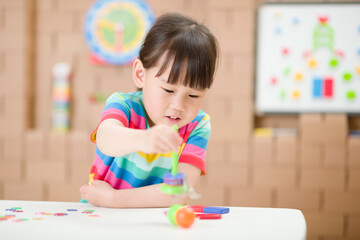 young  girl  play magical magnet experiments at home for homeschooling