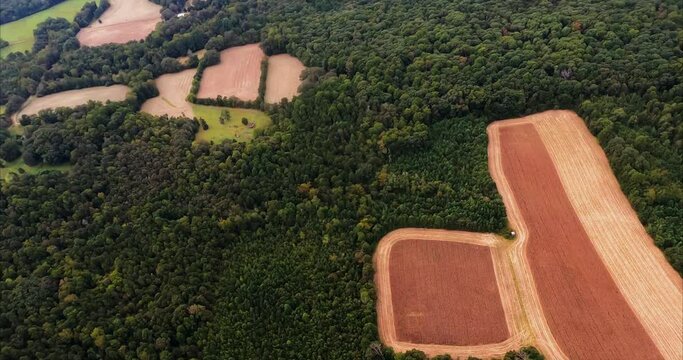 Unusual Two Color Plowed Field. We fly over an unusual combination of fields that is plowed but two different colors. Makes for quite a contrast. Surrounded by trees and forest. 