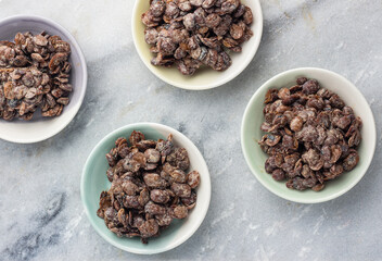 Fermented locust beans in small bowls - obrazy, fototapety, plakaty
