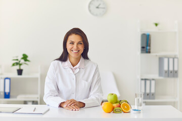 Dietician smiling to client or recording video about weight loss and healthy eating habits