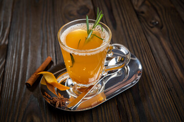 Hot mulled wine on a wooden table
