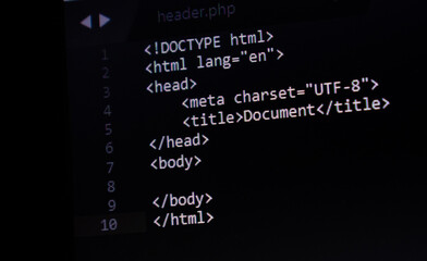 HTML basic code structure, web design and development source code in background in a text editor