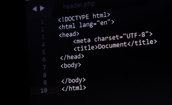 HTML basic code structure, web design and development source code in background in a text editor