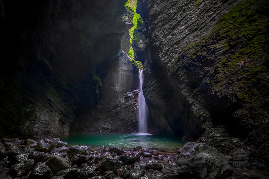 Beautiful waterfall in the dark cave.